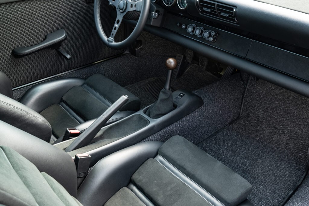 Classic 1989 Porsche 964 interior with manual transmission and vintage dashboard.