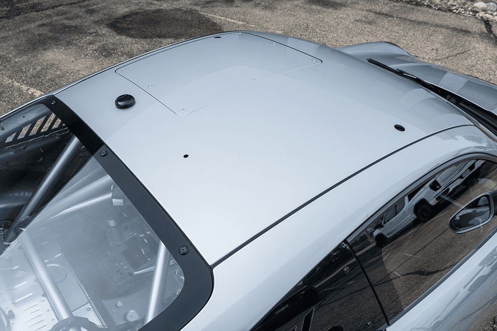 Close-up of the roof and windshield of a silver Porsche 911 GT3 Cup 992.