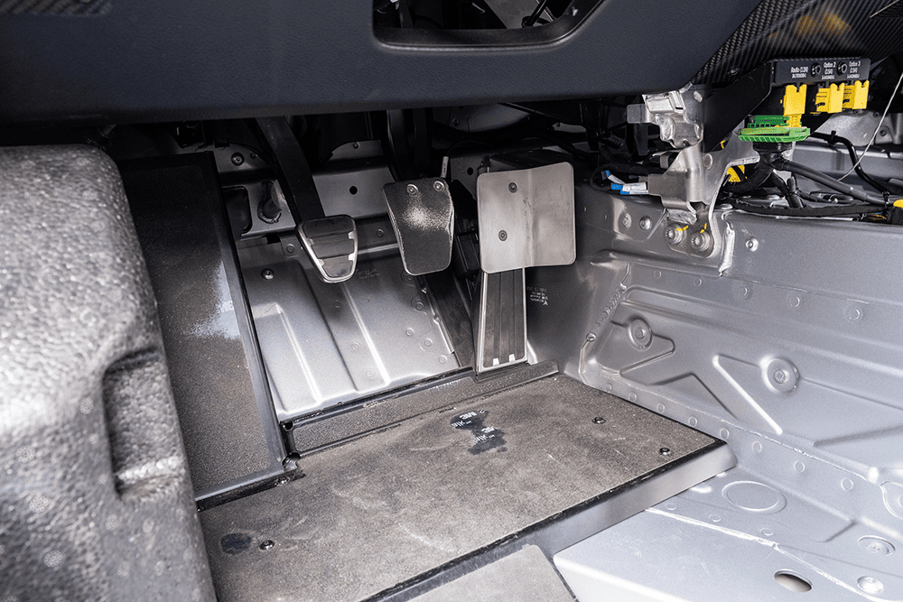 Close-up of the interior footwell of a 2021 Porsche 911 GT3 Cup 992 race car.