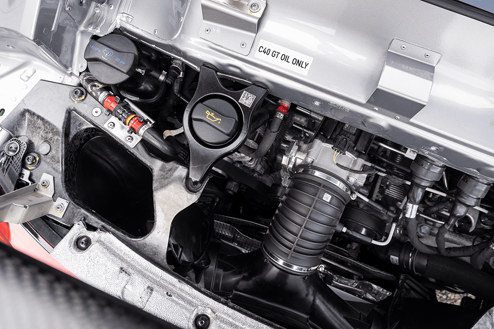 Close-up of Porsche 911 GT3 Cup 992 engine components and oil cap.