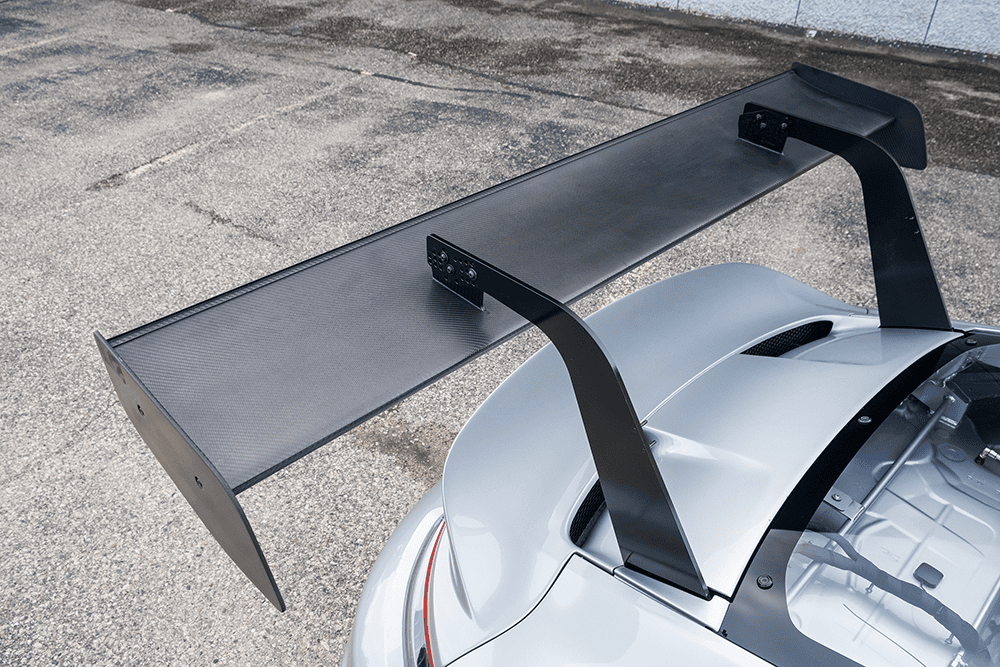 Close-up of a large rear wing on a silver Porsche 911 GT3 Cup 992.