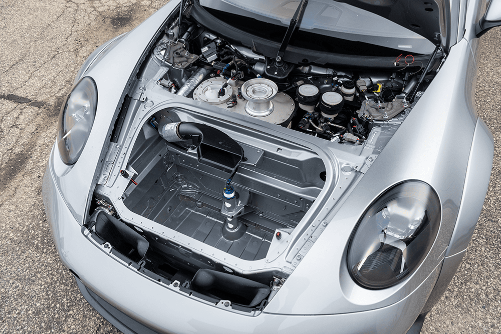 Close-up of a Porsche 911 GT3 Cup 992 engine bay with detailed components.