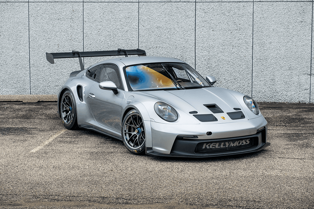 Silver Porsche 911 GT3 Cup 992 racing car with aerodynamic features.