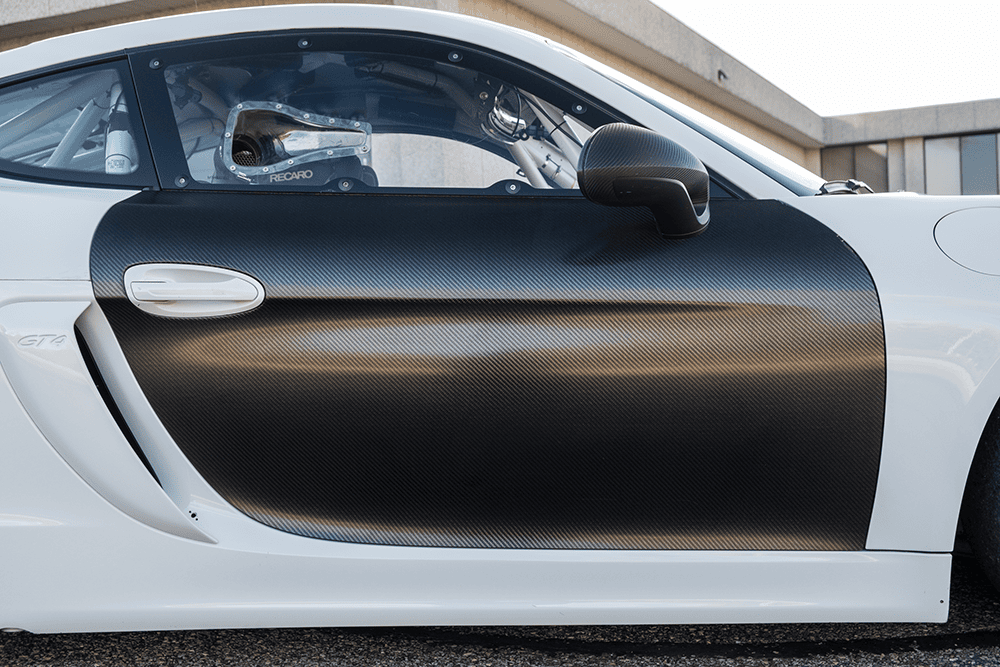 Close-up of a Porsche 981 Clubsport MR with carbon fiber door panel.