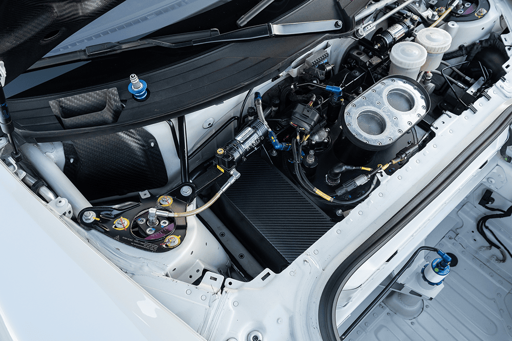 Close-up of Porsche 981 Clubsport MR engine bay with high-performance components.