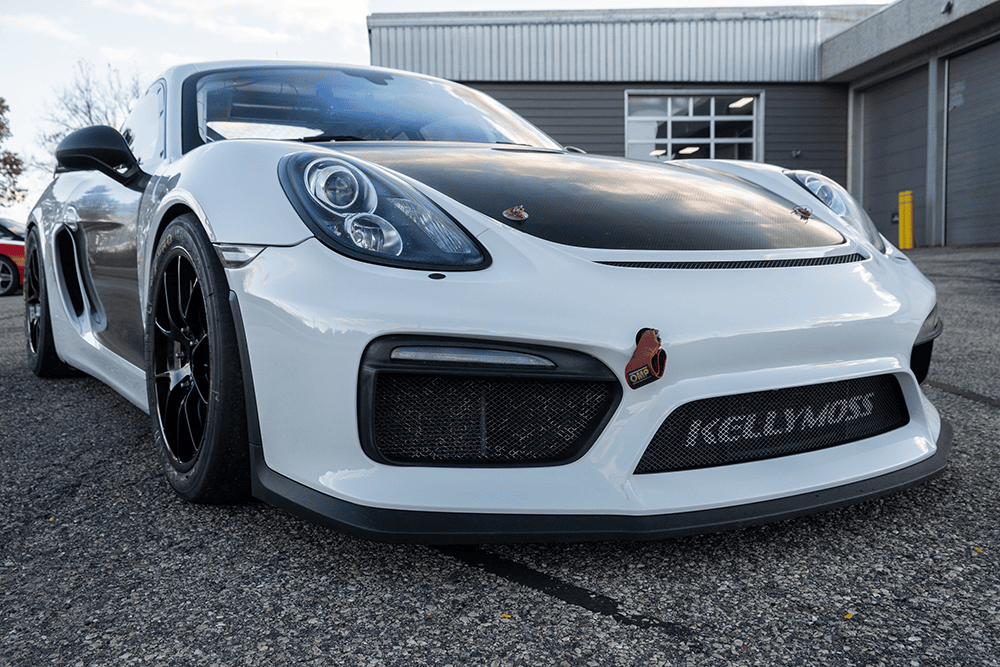 2016 Porsche 981 Clubsport MR with custom black hood and racing features.