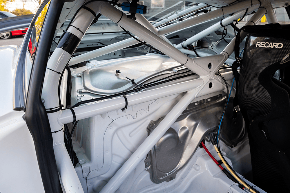 Close-up of racing car interior with roll cage and Recaro seat for 2016 Porsche 981 Clubsport MR.