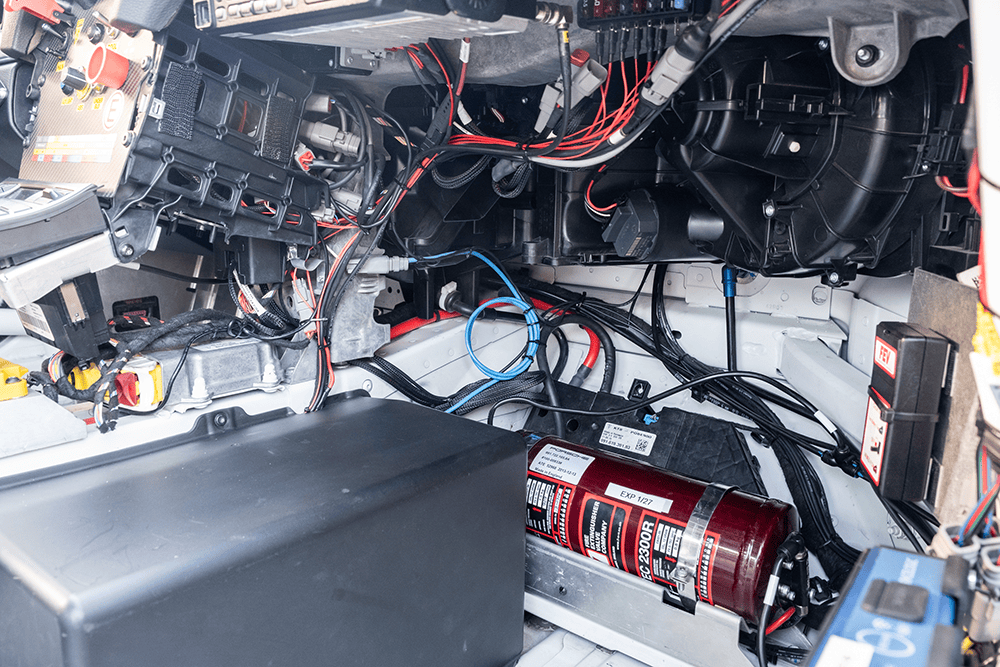 Close-up of electrical wiring and components inside a Porsche 981 Clubsport MR.