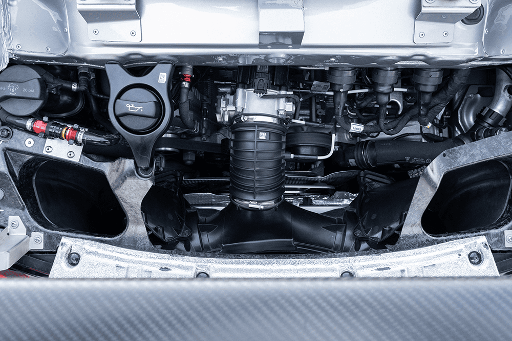 Close-up of Porsche 911 GT3 Cup 992 engine and mechanical components.