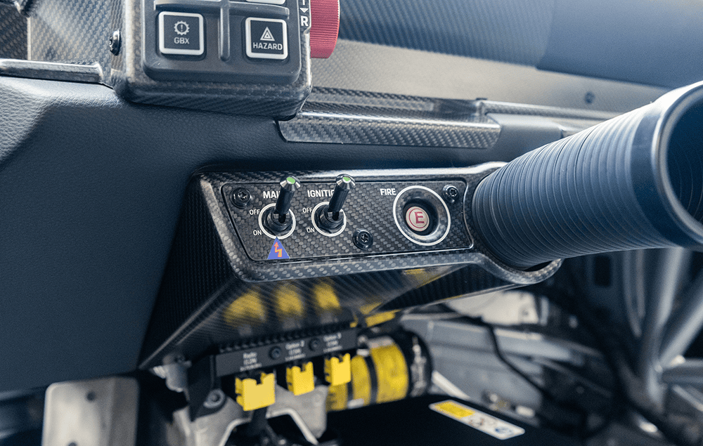 Close-up of Porsche 911 GT3 Cup 992 dashboard and steering wheel.