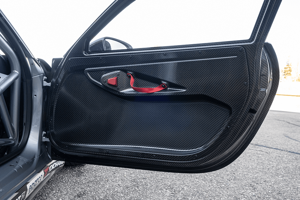 Close-up of the carbon fiber interior door of a Porsche 911 GT3 Cup 992.