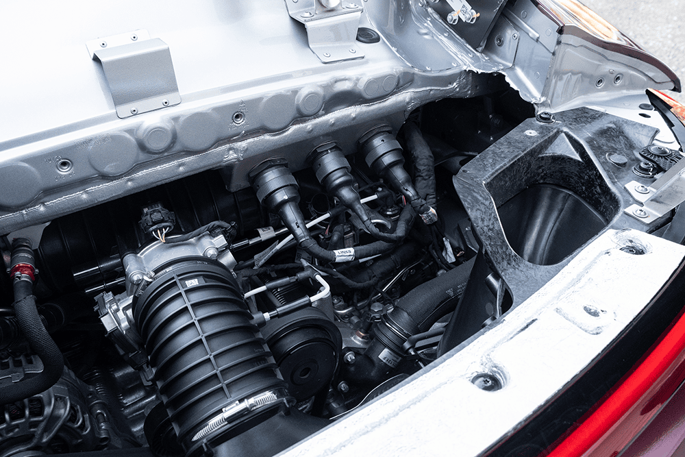 Close-up of the engine bay of a Kellymoss Porsche 911 GT3 Cup race car.