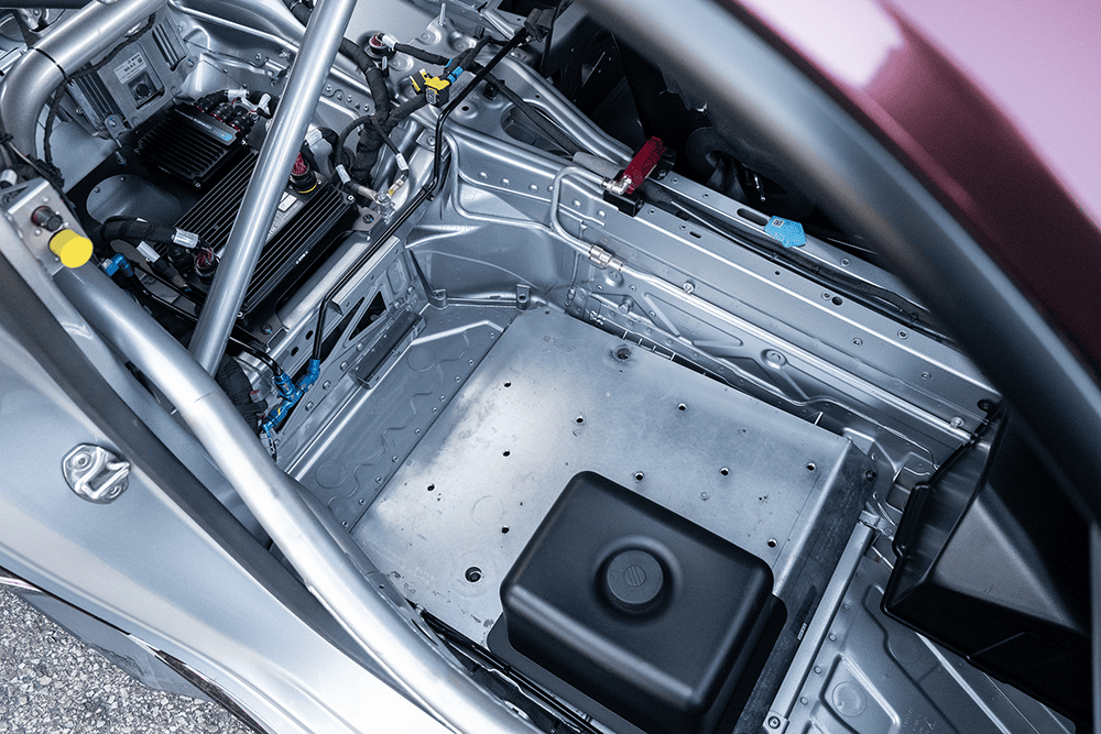 View of the racing car's interior showing chassis and electronic components.
