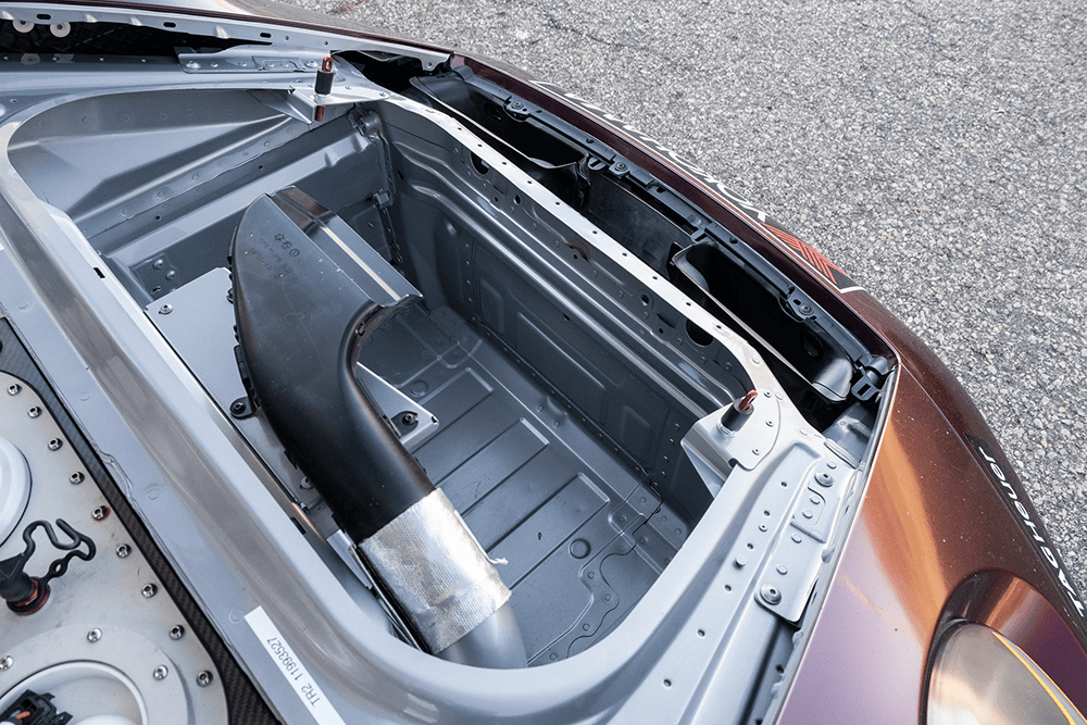 Close-up of the engine bay of a Porsche 911 GT3 Cup 992 race car.
