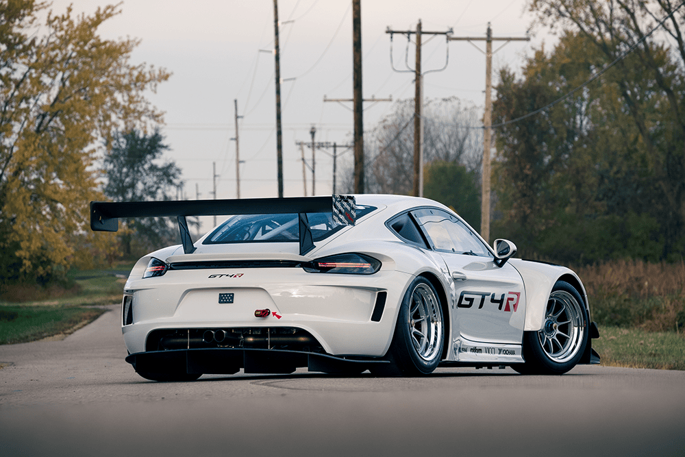 Kellymoss GT4R race car on a rural road with trees and power lines.