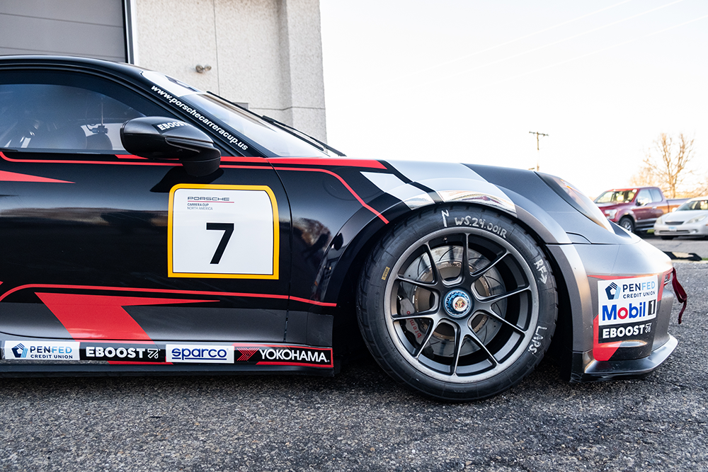 Close-up of a black Porsche 911 GT3 Cup race car with racing decals.