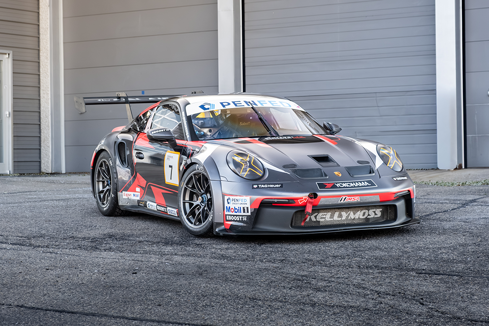 Kellymoss Porsche 911 GT3 Cup race car in a garage setting.