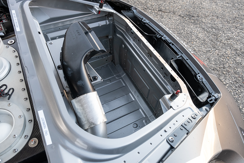 Close-up of the engine bay of a 2022 Porsche 911 GT3 Cup 992 race car.