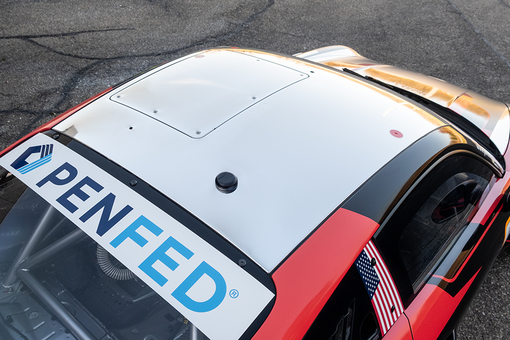 Close-up of Kellymoss Porsche 911 GT3 Cup 992 race car with sponsor decals.