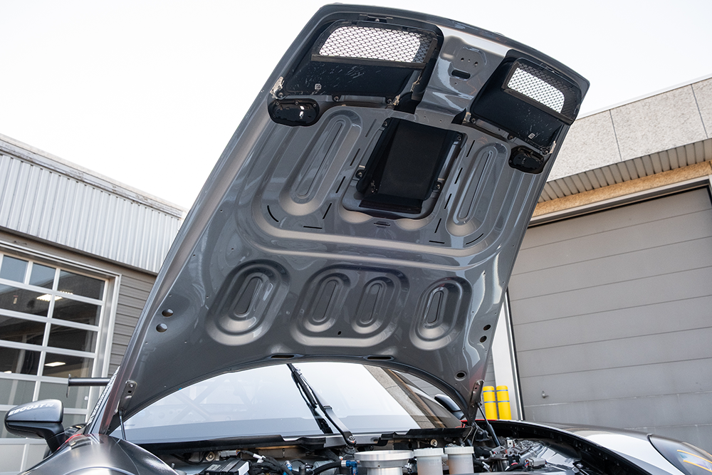 Close-up of the open engine hood of a Porsche 911 GT3 Cup 992.