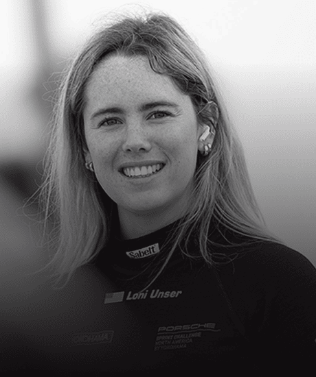 Portrait of a female race car driver in racing suit at Pirelli GT4 America event.