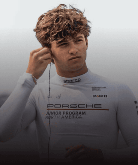 Young race car driver in Porsche Junior Program gear at Porsche Carrera Cup North America.