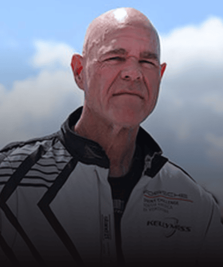 Porsche racing driver in racing suit at Kellymoss event during Porsche Sprint Challenge.