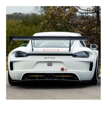 White Kellymoss GT4R race car with rear wing on a track.
