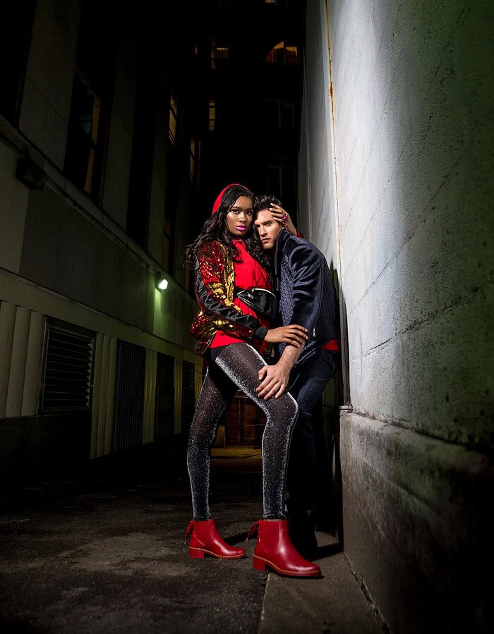 Fashion photo of two models in urban night setting with bold style.