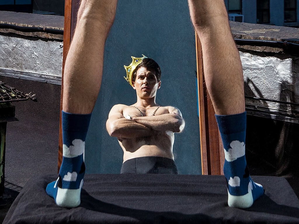 Fashion photo inspired by fairy tales with a woman wearing a crown and socks.