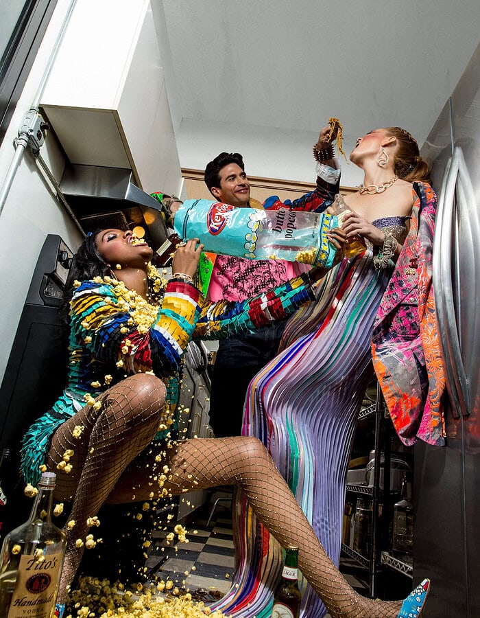 Fashion photo-essay scene with vibrant outfits and playful interaction.