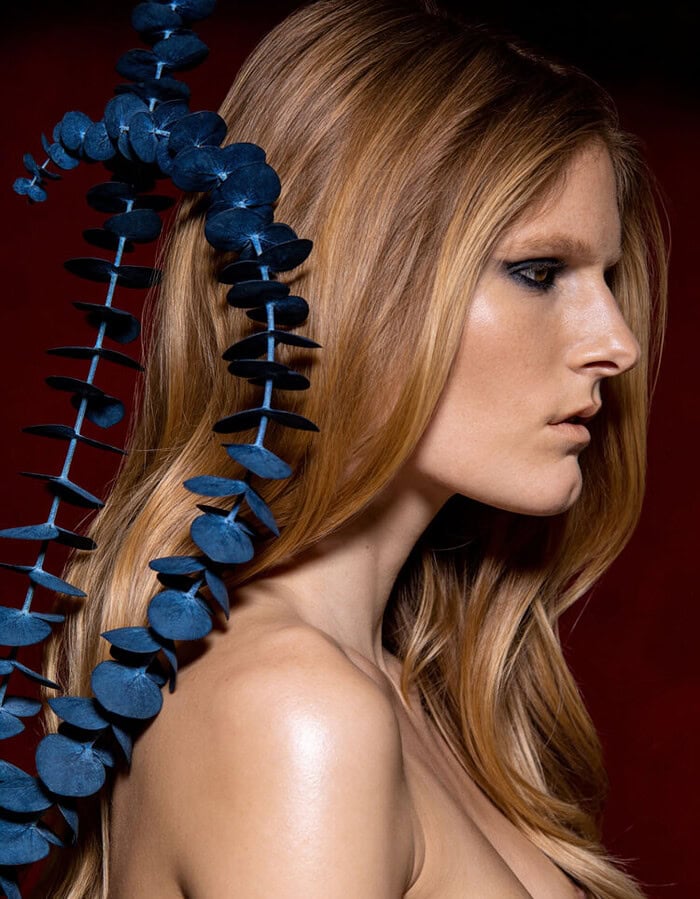 Fashion portrait of a woman with long red hair and blue floral accessory. photographer NYC