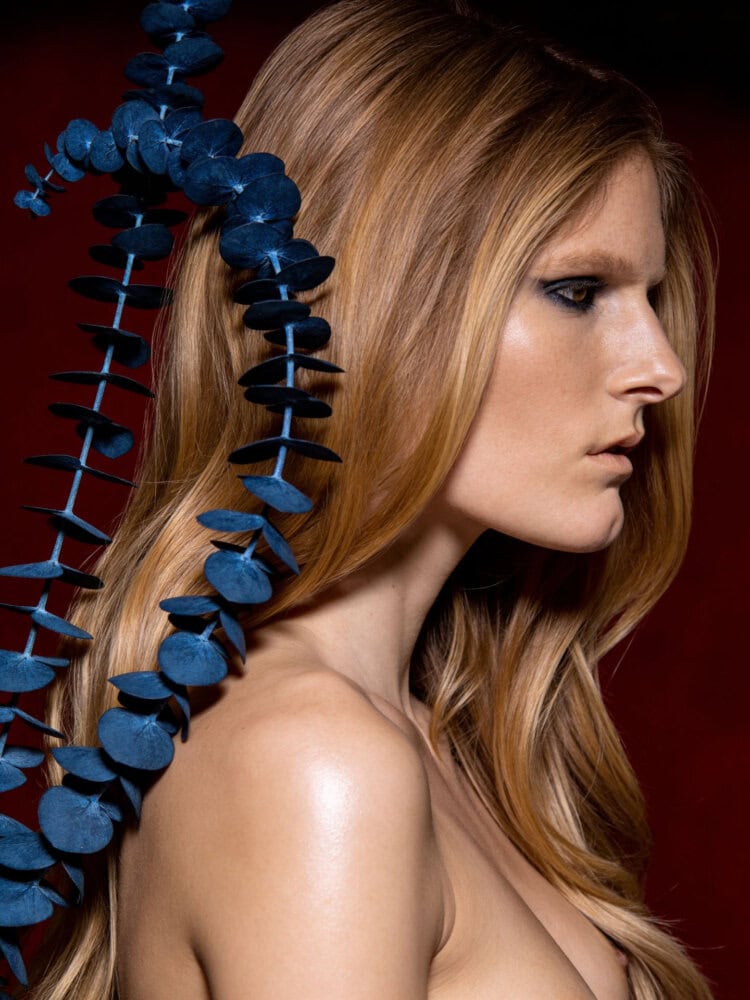 Fashion portrait of a woman with long red hair and blue floral accessory. photographer NYC