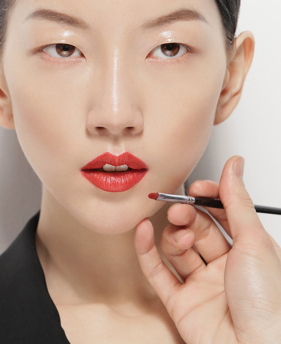 Close-up of a woman getting her makeup done with a brush. photographer NYC