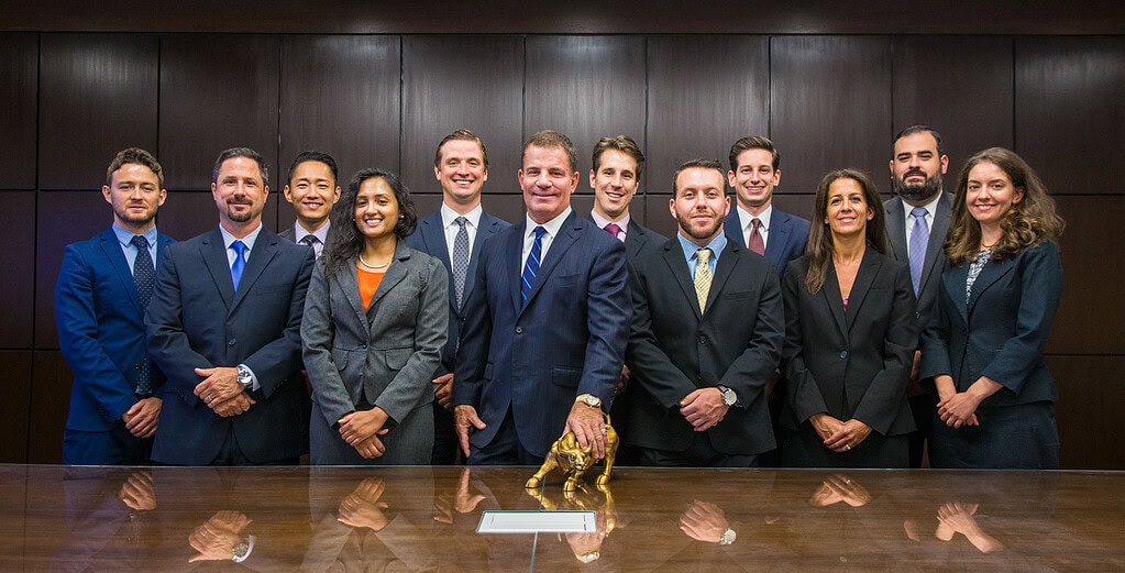 Financial services team posed for a corporate group portrait in a boardroom.
