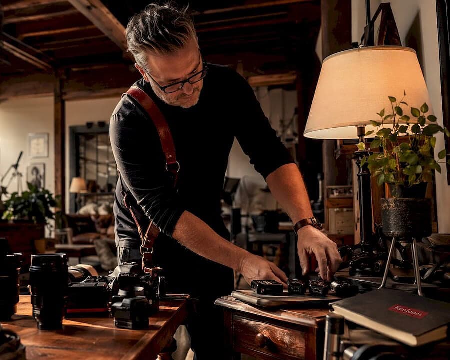 Photographer arranging professional camera gear in NYC studio