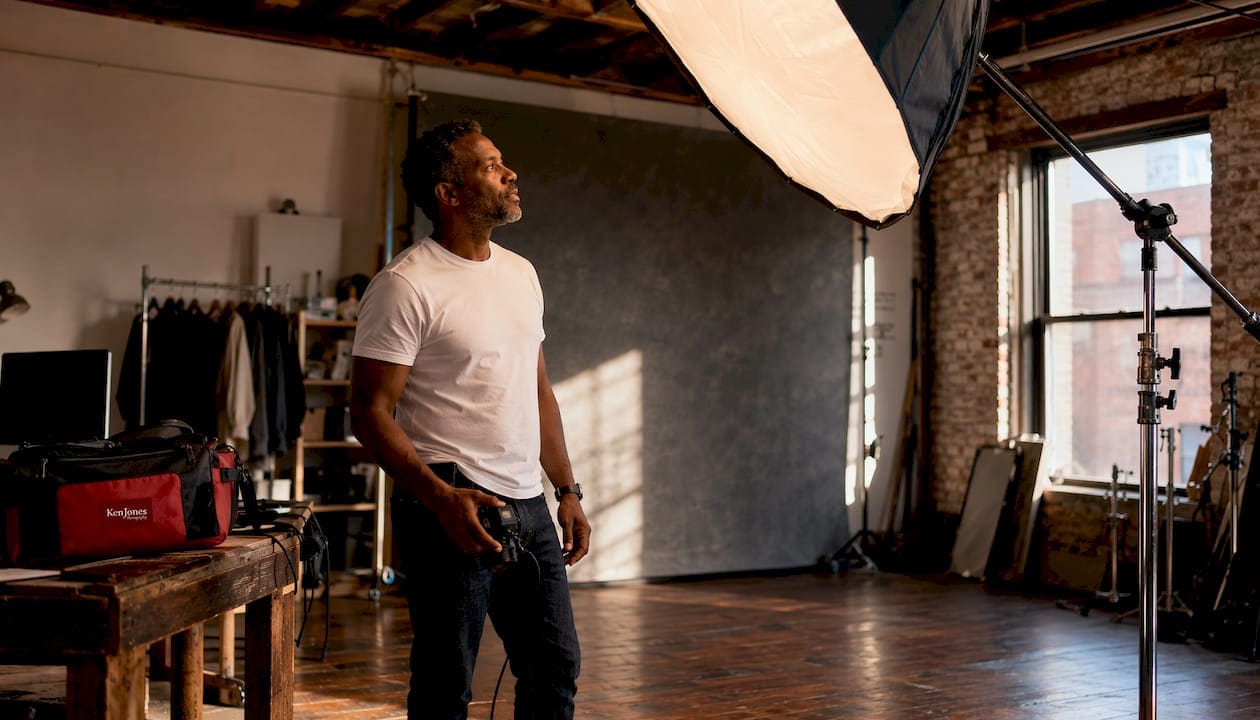 Photographer assessing studio lighting setup
