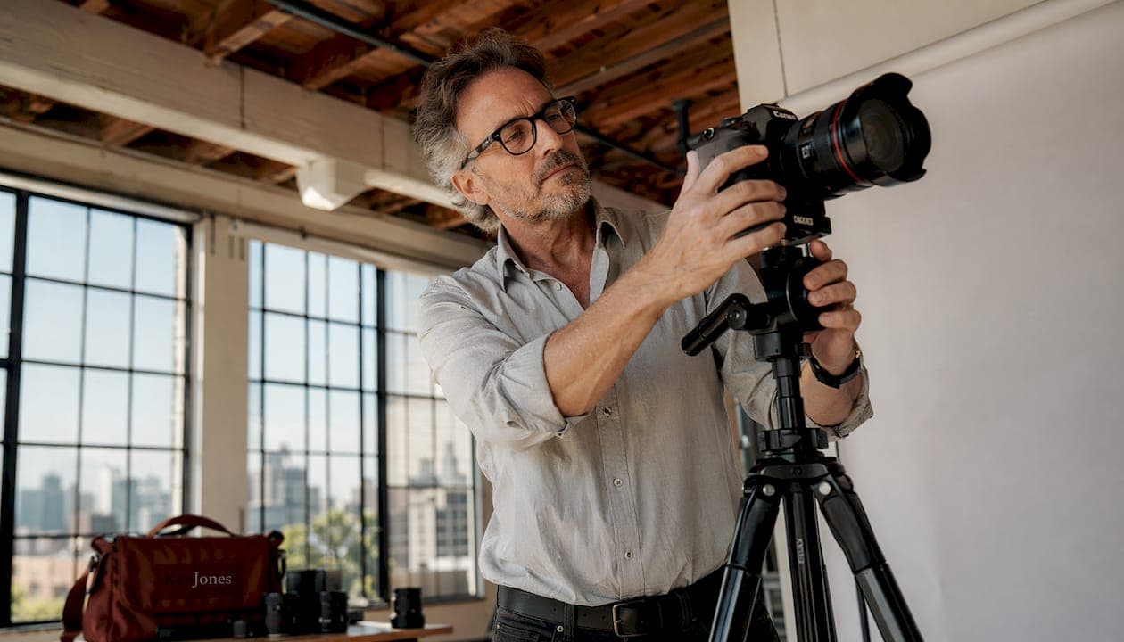 Photographer adjusting camera in NYC studio