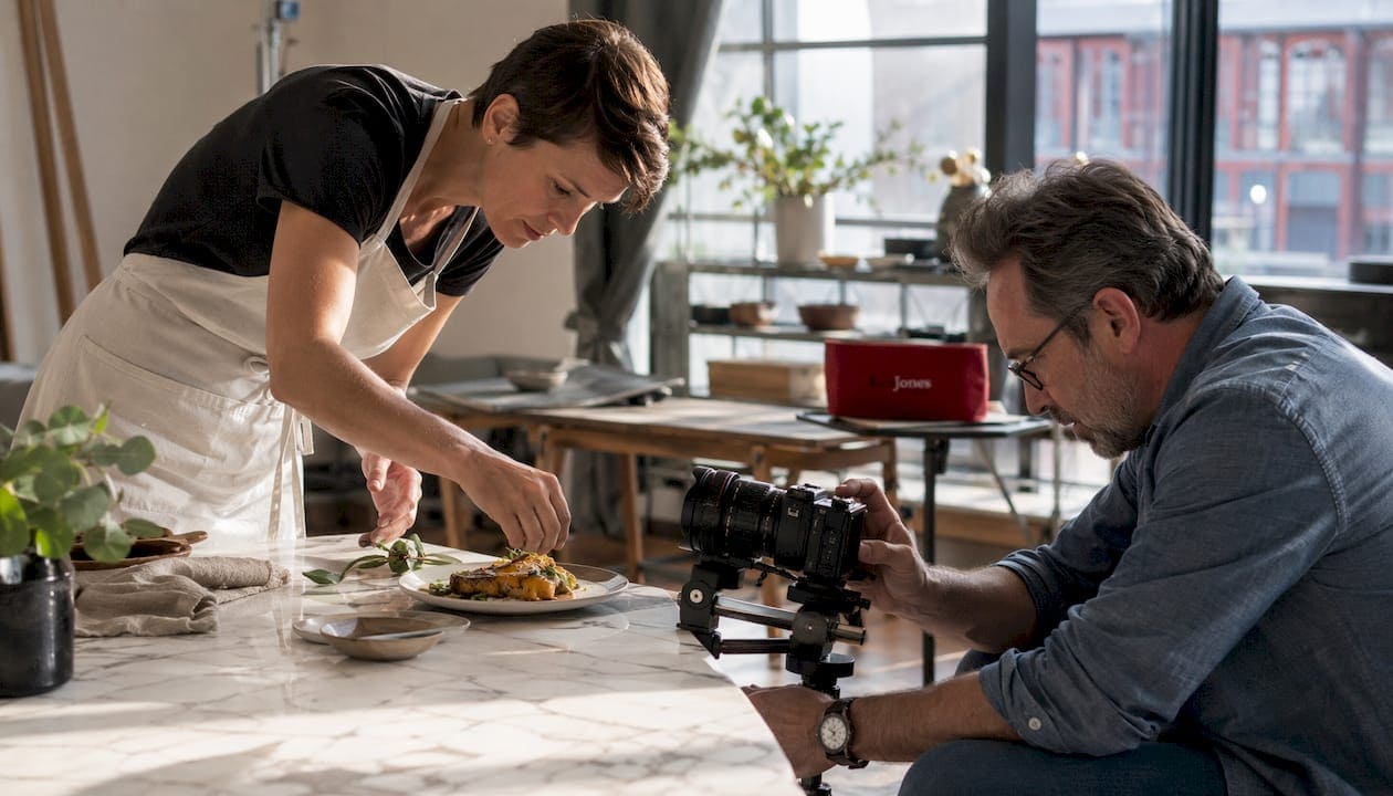Food stylist and photographer collaborating on food shoot