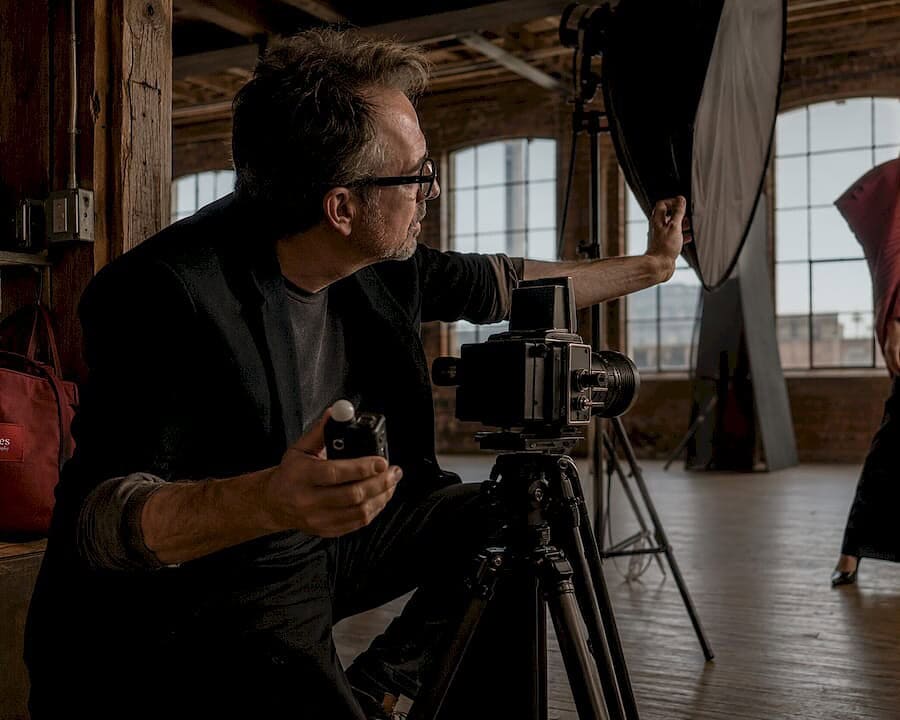 Fashion photographer preparing studio shoot