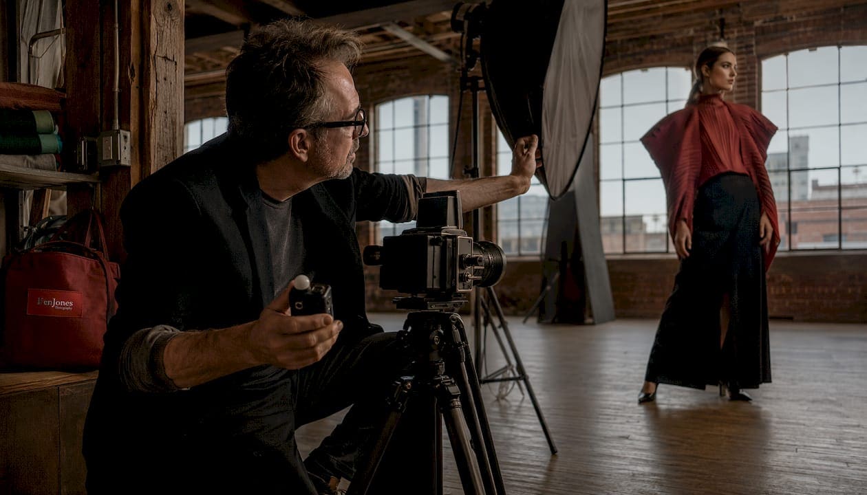 Fashion photographer preparing studio shoot