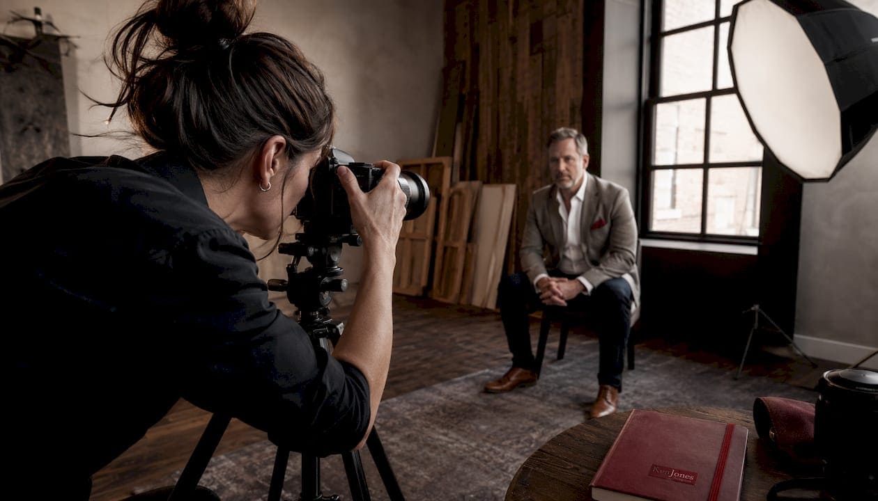 Photographer capturing precise headshot lighting setup