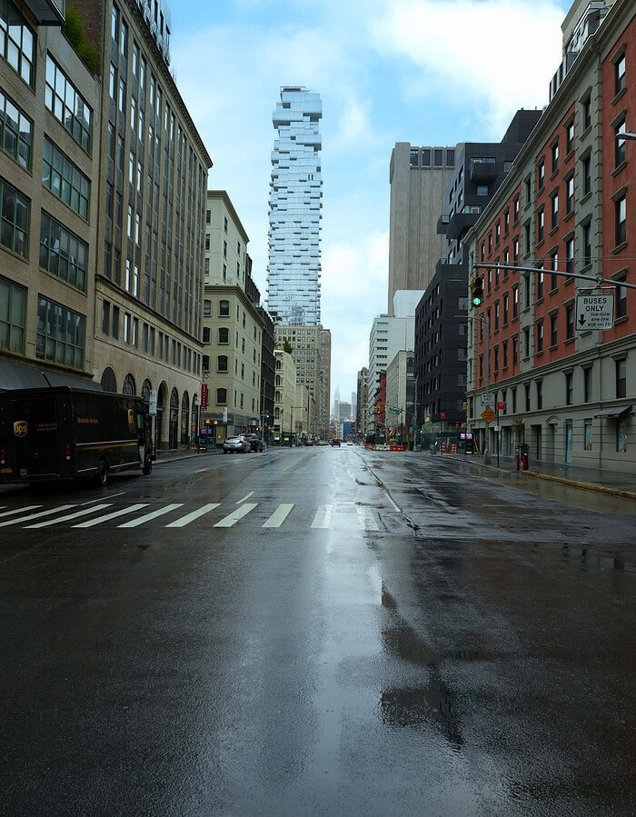 Wet empty Lower Manhattan street during COVID with 56 Leonard rising in the distance.