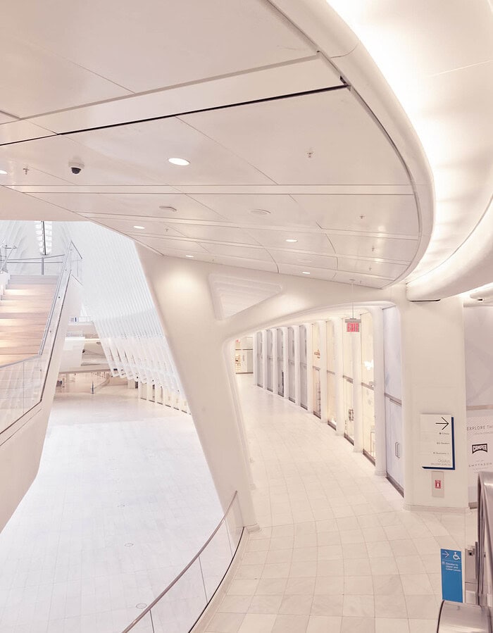 White curved interior architecture inside the World Trade Center Oculus during a quiet COVID-era moment.