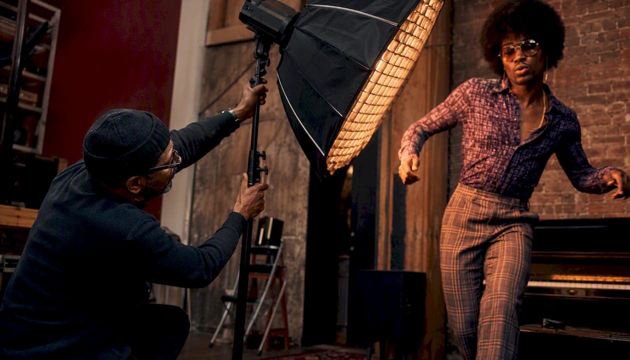 Photographer adjusting lighting for dynamic music portrait