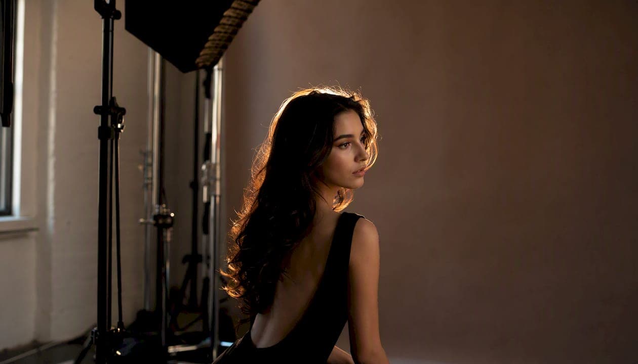 Hair light creating editorial glow on model
