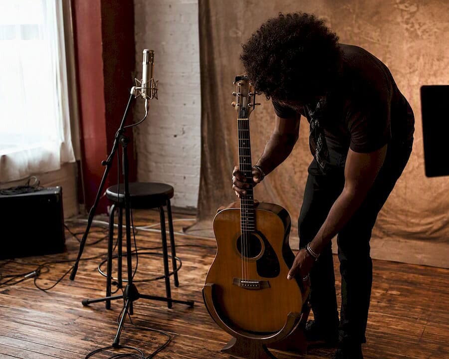 Music artist preparing guitar in studio