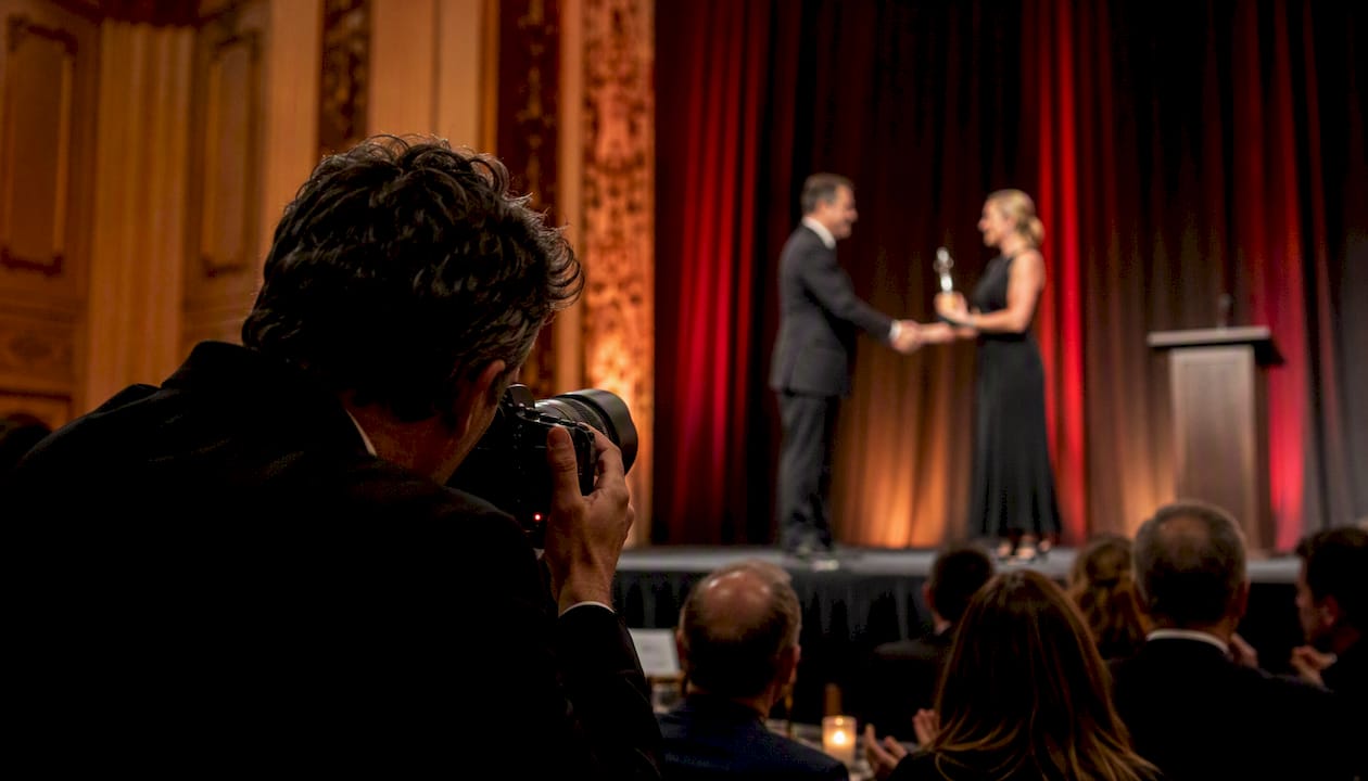 Photographer shooting award winner on stage