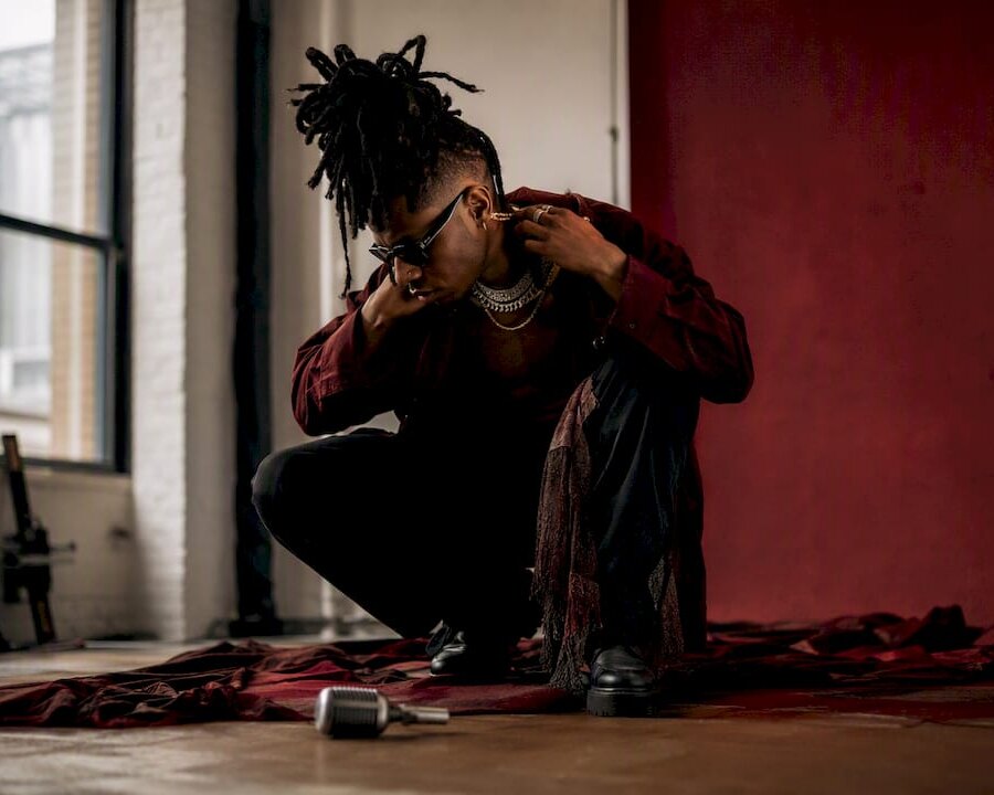 Music artist adjusting accessory during studio shoot