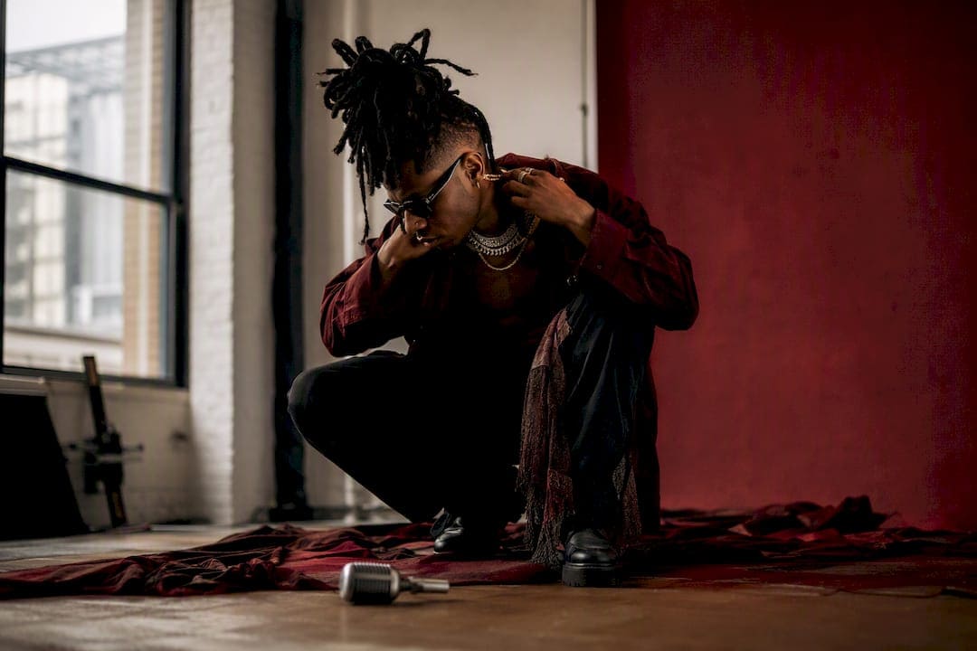 Music artist adjusting accessory during studio shoot